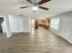 Open living space with laminate floors, neutral paint, and views to kitchen at 4884 Browns Mill Ferry Rd, Lithonia, GA 30038