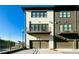 Contemporary townhome showcasing modern architecture and a convenient two-car garage, with a charming balcony at 6666 Sterling Dr, Sandy Springs, GA 30328
