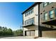 Attractive townhome featuring a private balcony, garage, and a modern exterior design at 6666 Sterling Dr, Sandy Springs, GA 30328