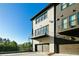 Contemporary townhome showcasing modern architecture and a convenient two-car garage, with a charming balcony at 6666 Sterling Dr, Sandy Springs, GA 30328