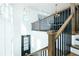 Elegant foyer with staircase featuring wood and metal banister at 6666 Sterling Dr, Sandy Springs, GA 30328