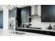 Modern kitchen with stainless steel appliances, subway tile backsplash, and dark cabinetry at 6666 Sterling Dr, Sandy Springs, GA 30328