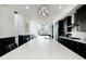 Modern kitchen featuring a long island with bar seating, stainless steel appliances, and stylish pendant lights at 6666 Sterling Dr, Sandy Springs, GA 30328