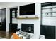 Contemporary living room featuring a white brick fireplace and a modern TV at 6666 Sterling Dr, Sandy Springs, GA 30328
