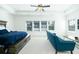 Spacious main bedroom featuring a large bed, comfortable couch, and a ceiling fan at 6666 Sterling Dr, Sandy Springs, GA 30328