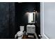 Stylish powder room with unique textured wallpaper and modern fixtures at 6666 Sterling Dr, Sandy Springs, GA 30328