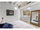 Bedroom with a large mirror, exposed ceiling, and a view of the adjacent building at 805 Peachtree Ne St # 220, Atlanta, GA 30308