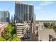 Expansive city view featuring modern high-rise apartments and lush green trees against a clear, blue sky at 805 Peachtree Ne St # 220, Atlanta, GA 30308
