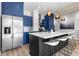 Modern kitchen with stainless steel appliances, island with stools and a large refrigerator at 805 Peachtree Ne St # 220, Atlanta, GA 30308