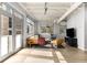 Bright living room with neutral tones, large windows and patio access featuring stylish seating arrangements at 805 Peachtree Ne St # 220, Atlanta, GA 30308