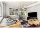Cozy living area with stylish seating, a television, and large windows offering natural light and neighborhood views at 805 Peachtree Ne St # 220, Atlanta, GA 30308