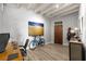 Home office features wood flooring, a bicycle, and a modern desk setup, ideal for a productive work environment at 805 Peachtree Ne St # 220, Atlanta, GA 30308