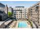 Beautiful rooftop pool with lounge chairs surrounded by downtown buildings at 805 Peachtree Ne St # 220, Atlanta, GA 30308