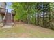 Spacious backyard area with trees and stairs leading to an upper deck, great for outdoor activities at 861 Southland Pass, Stone Mountain, GA 30087