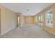 Basement area with ceiling fan, natural light from doors to the exterior, and neutral walls at 861 Southland Pass, Stone Mountain, GA 30087