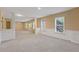 Large basement area with modern carpeting, columns, and bright natural light from the windows at 861 Southland Pass, Stone Mountain, GA 30087