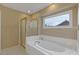 Bright bathroom featuring a soaking tub, separate shower, and a large window at 861 Southland Pass, Stone Mountain, GA 30087