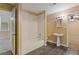 Bathroom features a shower-tub combo, pedestal sink, and black tile flooring at 861 Southland Pass, Stone Mountain, GA 30087