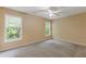 Bedroom featuring neutral walls, a ceiling fan, and two large windows at 861 Southland Pass, Stone Mountain, GA 30087