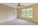 Bedroom featuring a ceiling fan, neutral walls, and a large window at 861 Southland Pass, Stone Mountain, GA 30087
