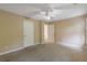 Bedroom features neutral walls, a ceiling fan, and access to additional rooms at 861 Southland Pass, Stone Mountain, GA 30087
