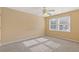 Bedroom featuring neutral walls, a ceiling fan, and two large windows at 861 Southland Pass, Stone Mountain, GA 30087
