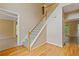 View of foyer featuring a hardwood floor, staircase with white banister, and views into other rooms at 861 Southland Pass, Stone Mountain, GA 30087
