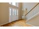 Foyer view showing hardwood floors, staircase, and front door with glass inlays at 861 Southland Pass, Stone Mountain, GA 30087