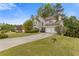 Charming traditional home with a two-car garage and long driveway leading up to the front entrance at 861 Southland Pass, Stone Mountain, GA 30087