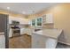 Bright kitchen features white cabinets, stainless steel appliances, and tile flooring at 861 Southland Pass, Stone Mountain, GA 30087