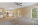 Open-concept living room with tile floors, fireplace, backyard access and adjacent kitchen at 861 Southland Pass, Stone Mountain, GA 30087