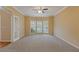 Spacious living room with neutral carpet, decorative molding, ceiling fan, and a bay window at 861 Southland Pass, Stone Mountain, GA 30087