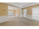 Spacious living room featuring neutral carpet, picture-frame molding, and large windows at 861 Southland Pass, Stone Mountain, GA 30087