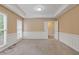 Neutral living room featuring carpet, a tray ceiling, picture-frame molding, and ample natural light at 861 Southland Pass, Stone Mountain, GA 30087