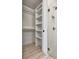 Walk in closet and bathroom shower featuring shelving and glass door at 140 Rolison Way, Fayetteville, GA 30214