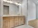 Bright bathroom with a double vanity, wooden cabinets, and modern fixtures at 140 Rolison Way, Fayetteville, GA 30214