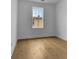 Bright bedroom with hardwood floors, a large window and neutral paint at 140 Rolison Way, Fayetteville, GA 30214