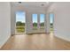 Bedroom with natural light coming from large windows and french doors to the balcony at 140 Rolison Way, Fayetteville, GA 30214