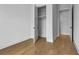 Bedroom with hardwood flooring, white walls, and closet and hallway access at 140 Rolison Way, Fayetteville, GA 30214