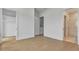 Spacious bedroom with light hardwood floors, a walk-in closet, and an en suite bathroom at 140 Rolison Way, Fayetteville, GA 30214