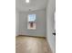 An empty, bright bedroom with white walls, hardwood floors, and a window at 140 Rolison Way, Fayetteville, GA 30214