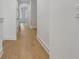 Hallway with hardwood floors, white walls and trim, and closet doors at 140 Rolison Way, Fayetteville, GA 30214