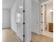 Bright hallway with hardwood floors and white doors leads to a bathroom at 140 Rolison Way, Fayetteville, GA 30214