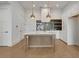 Kitchen with an island, stainless steel appliances, quartz countertops, and unique tile backsplash at 140 Rolison Way, Fayetteville, GA 30214