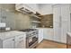 Stunning kitchen features stainless steel appliances and range with stylish finishes at 140 Rolison Way, Fayetteville, GA 30214