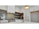 Close up of modern kitchen with tile backsplash, range, and quartz countertops at 140 Rolison Way, Fayetteville, GA 30214
