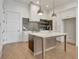Kitchen island featuring stainless steel appliances, ample storage, and open layout to the dining area at 140 Rolison Way, Fayetteville, GA 30214