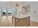 Modern kitchen with a center island, stainless steel appliances, and beautiful pendant lighting at 140 Rolison Way, Fayetteville, GA 30214