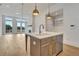 Open kitchen with a central island, pendant lighting, and stainless steel appliances at 140 Rolison Way, Fayetteville, GA 30214