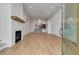 Open-concept living space with fireplace, modern kitchen, and hardwood floors for entertaining at 140 Rolison Way, Fayetteville, GA 30214